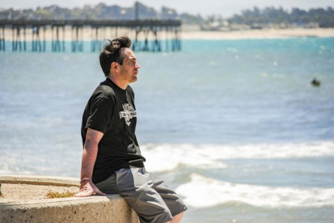 A man looking the ocean near Ventura Pier