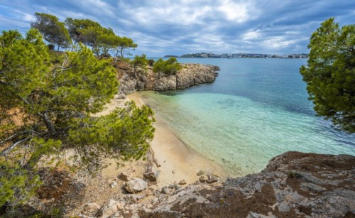 Small bay with sandy beach and blue sea