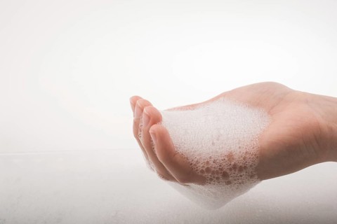 Hand washing and soap foam on a foamy background