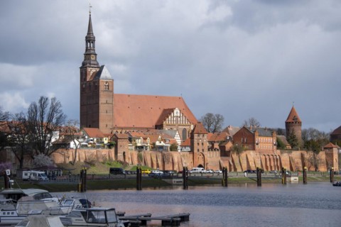 Historic town wall with defence defence tower and St. Stephens Church