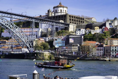 View of the Dom Luis I bridge over Douro River and terracota rooftops