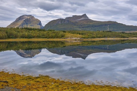 Fjord with reflection of the mountains