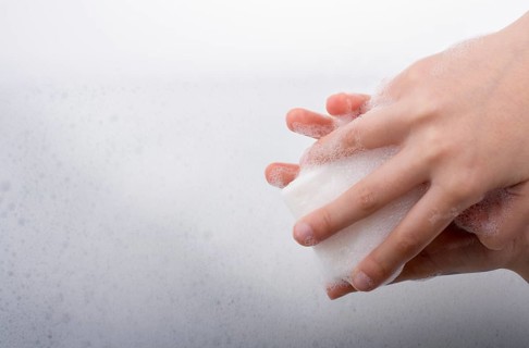 Hand washing and soap foam on a foamy background