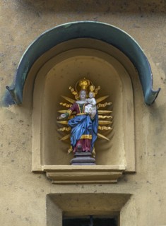 Sculpture of Mary with the Child Jesus in a niche on a residential house
