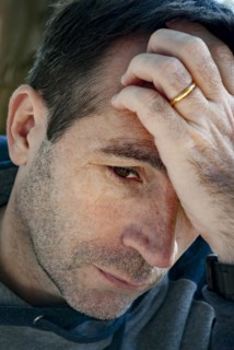 Worried man thinking with his hand on his forehead