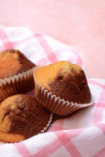 Chocolate muffins in kitchen towel
