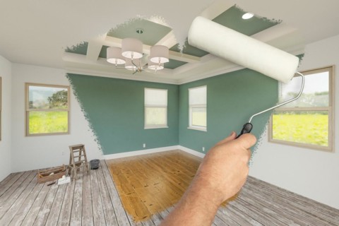 Before and after of man using A paint roller to reveal newly remodeled room with fresh muted teal paint