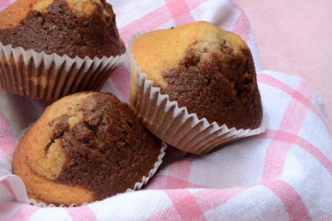 Chocolate muffins in kitchen towel