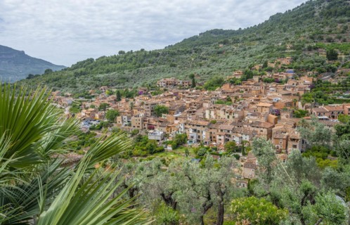 View of typical houses of the mountain village Fornalutx with mountain landscape
