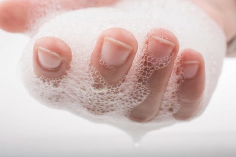 Hand washing and soap foam on a foamy background