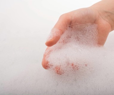 Hand washing and soap foam on a foamy background