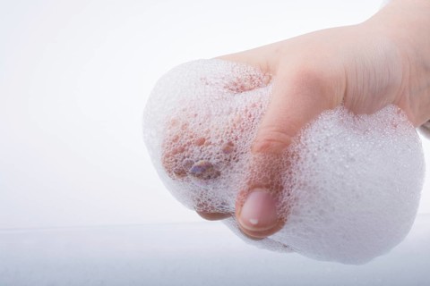 Hand washing and soap foam on a foamy background