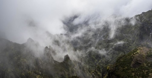 Steep cloudy mountain landscape with rock formations