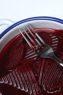 Sliced pickled beetroot with peel and fork