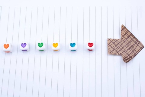 Love cubes and paper arrow on a notebook