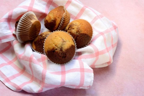 Chocolate muffins in kitchen towel