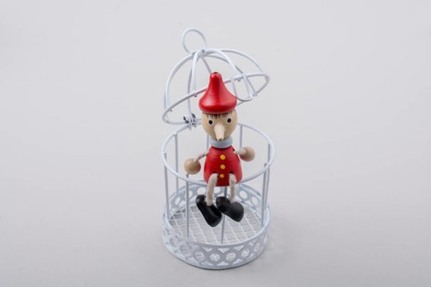 Metal cage and Little puppet pinocchio made of wood