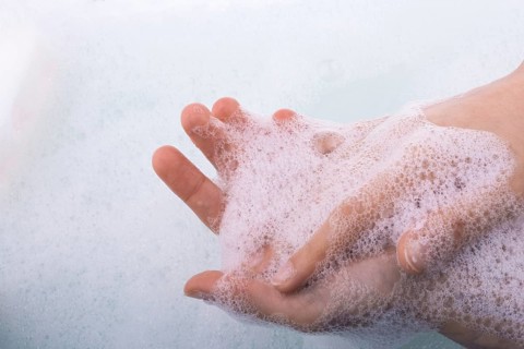 Hand washing and soap foam on a foamy background