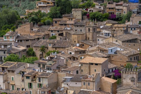 View of typical houses of the mountain village Fornalutx with church Parroquia catolica La Natividad de la virgen Maria
