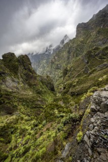 Steep cloudy mountain landscape with rock formations