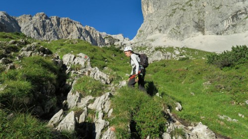 Tourist with equipment on a mountain trail in the Alps. Zugspitze massif