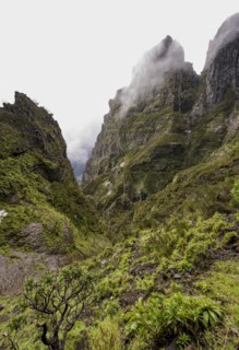 Steep cloudy mountain landscape with rock formations