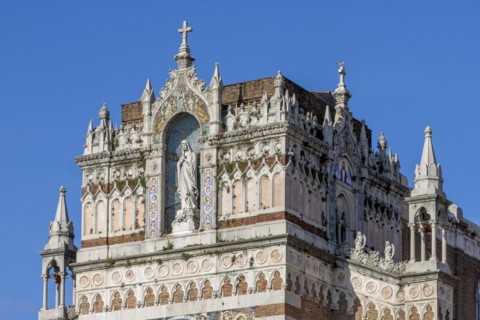 Detail of the top of the facade of the Capuchin Church of Our Lady of Lourdes with a statue of Our Lady of Lourdes decorated with a mosaic