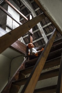 Attic with doll on stairs