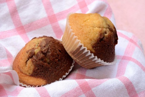 Chocolate muffins in kitchen towel