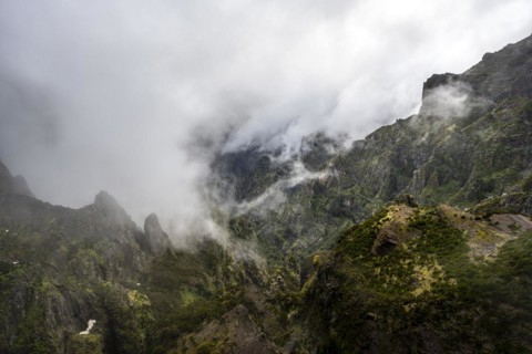 Steep cloudy mountain landscape with rock formations