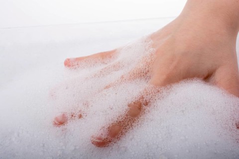 Hand washing and soap foam on a foamy background