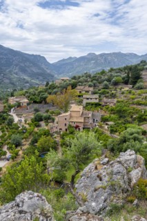 View over typical houses of the mountain village Fornalutx with mountain landscape