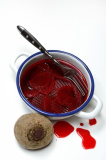 Sliced pickled beetroot with peel and fork