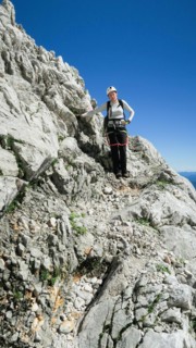 Womans crossing the via ferrata trail in the alps. Zugspitze massif