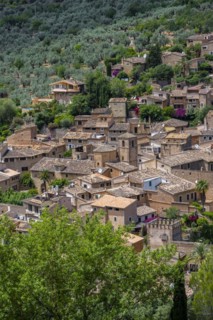 View of typical houses of the mountain village Fornalutx with church Parroquia catolica La Natividad de la virgen Maria