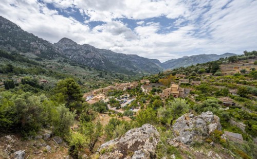 View of typical houses of the mountain village Fornalutx with mountain landscape