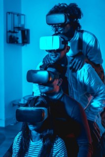 Group of young people with vr glasses in a virtual reality game in a blue light