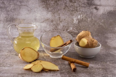Jar of fresh ginger tea with lemon and cinnamon
