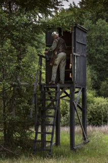 Hunter at a raised hide