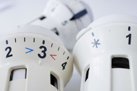 Symbolic photo on the subject of increased heating costs. Thermostats of radiators. Berlin