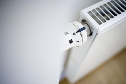 Symbol photo on the subject of increased heating costs. The thermostat of a heating system is set to the symbol snowflake