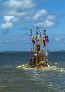 Decorated crab cutter sailing towards the island of Spiekeroog