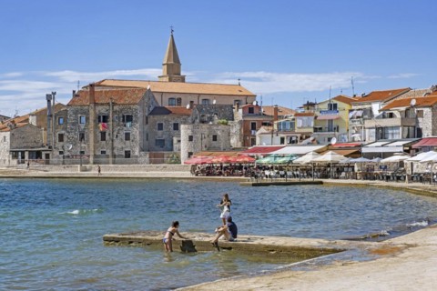 Terraces of restaurants along the waterfront in the town Umag
