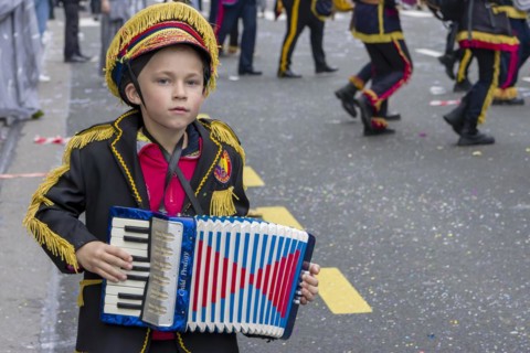 A masked boy with an accordion at the carnival in Rijeka