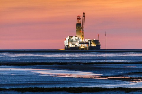 View from the Trischendamm to Germanys only drilling platform Mittelplate after sunset at low tide