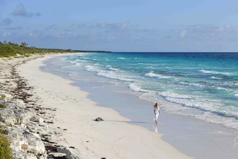 Tourist on the beach of Highbourne Cay