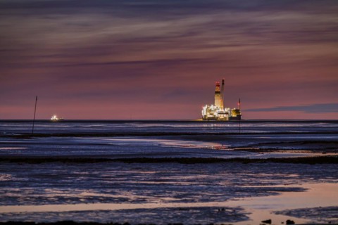 Germanys only oil rig Mittelplate at night and low tide