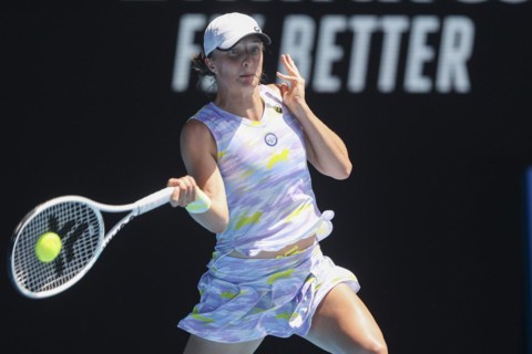 Polish tennis player Iga Swiatek plays a forehand shot during the Australian Open 2022 tournament at Melbourne Park