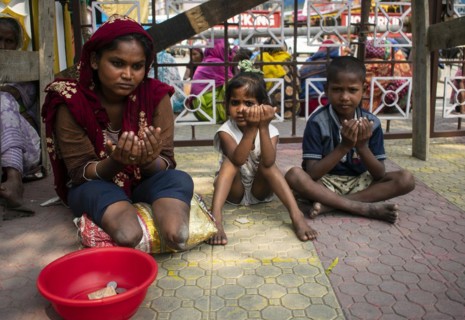 Indian Muslim woman with children perform the second Friday prayer in the holy month of Ramadan near a Mosque in Guwahati