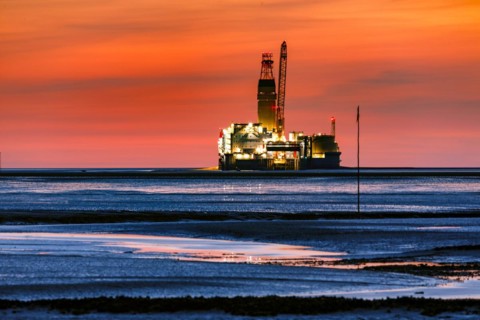View from the Trischendamm to Germanys only drilling platform Mittelplate after sunset at low tide
